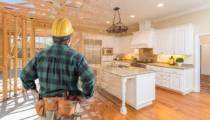 A contractor inspecting a kitchen during a r