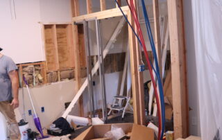 View of plumbing in wall during remodeling.