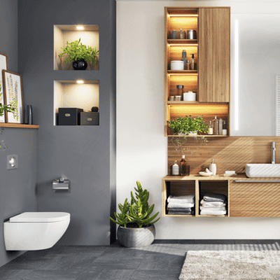 Modern bathroom with floating toilet, wooden shelves, plants, and decorative items.