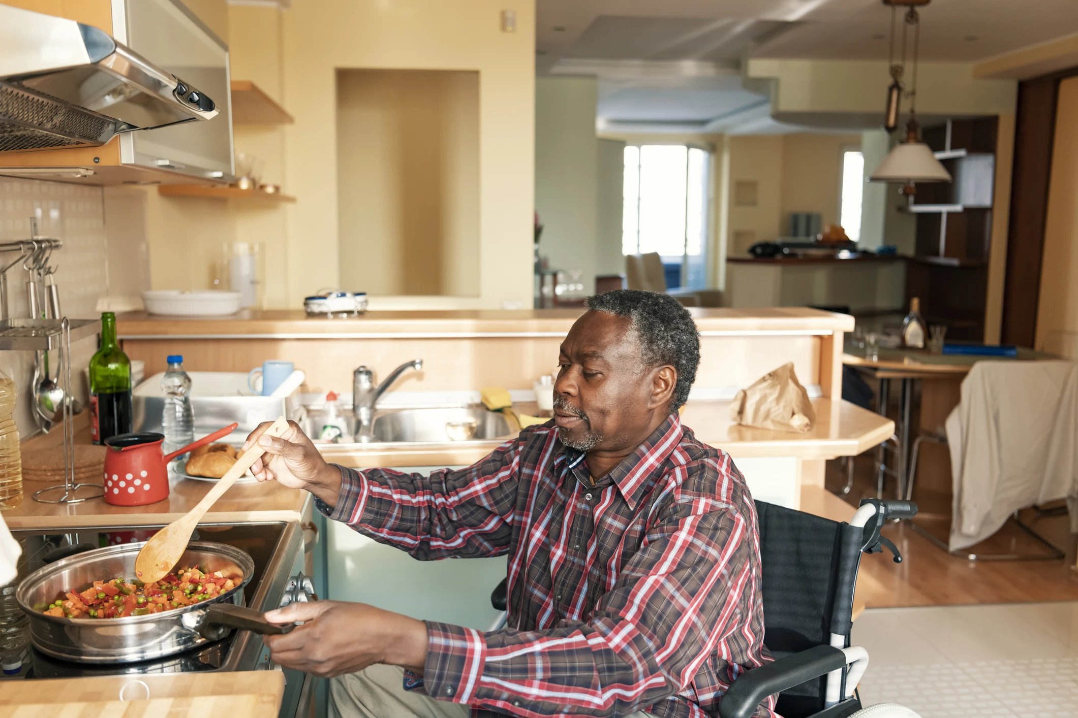 Senior in Wheelchair Preparing a Lunch at Home