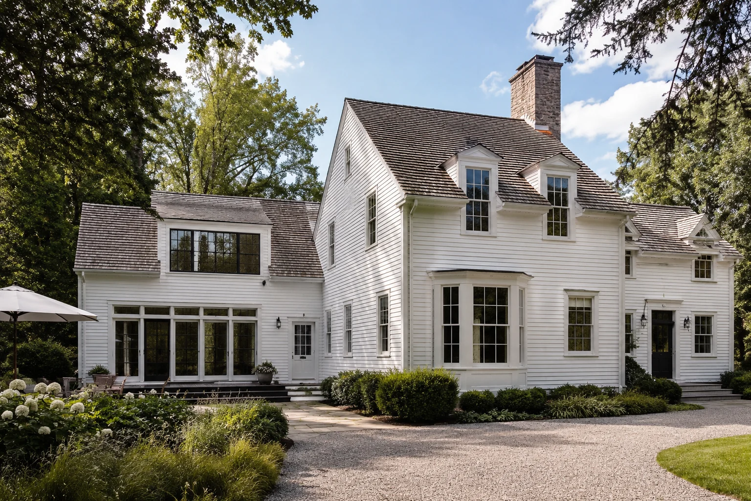 Classic Connecticut home with a refined addition featuring a seamlessly integrated roofline, matching roof pitch, and balanced New England architectural details.