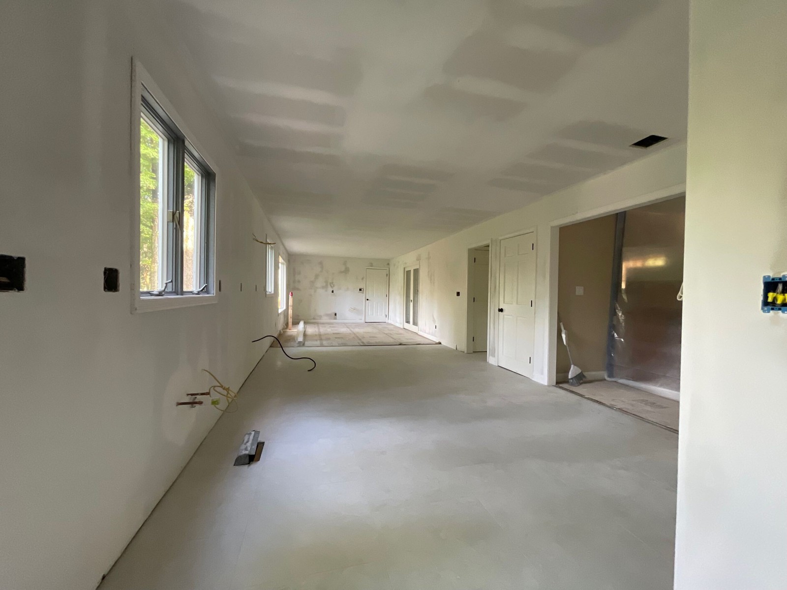 Hayes kitchen with tile installed and drywall finishing underway before cabinet installation